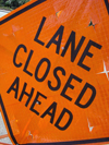 #2000008 - Orange road sign Lane closed ahead